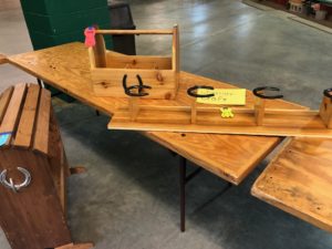 wood craft decorated with horseshoes