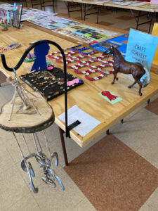 Various horse related crafts including a wind chime made of horseshoes. 